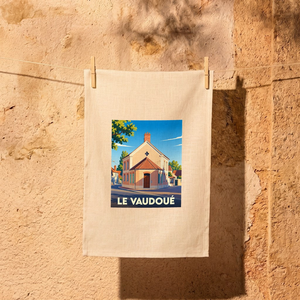 Torchon souvenir de la ville du Vaudoué avec une illustration stylisée d'un bâtiment local.