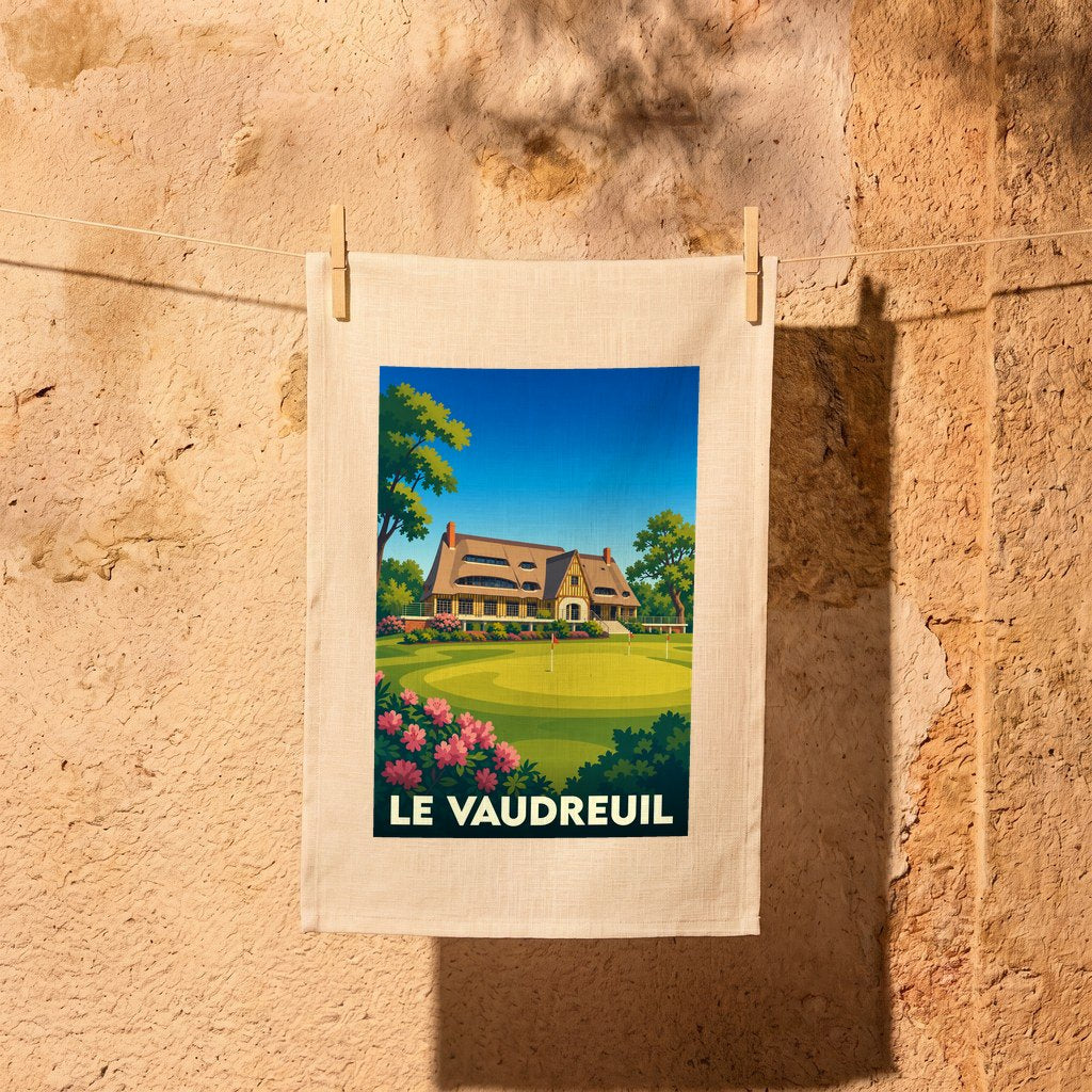 Torchon souvenir de la ville de Le Vaudreuil avec une illustration stylisée d'un parcours de golf et d'un manoir normand.