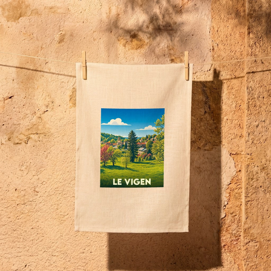 Torchon souvenir de la ville de Le Vigen illustrant un paysage de campagne ensoleillé.