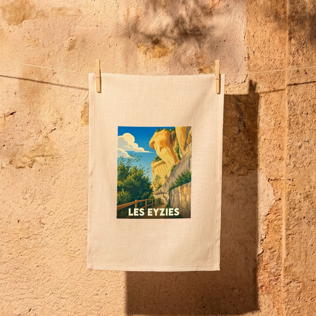 Torchon souvenir de la ville de Les Eyzies avec une illustration stylisée de ses falaises.