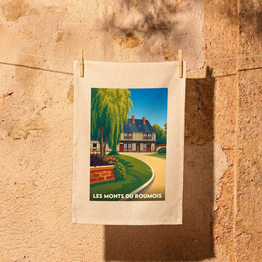 Torchon souvenir de la ville de Les Monts du Roumois avec une illustration stylisée d'une maison à colombages.