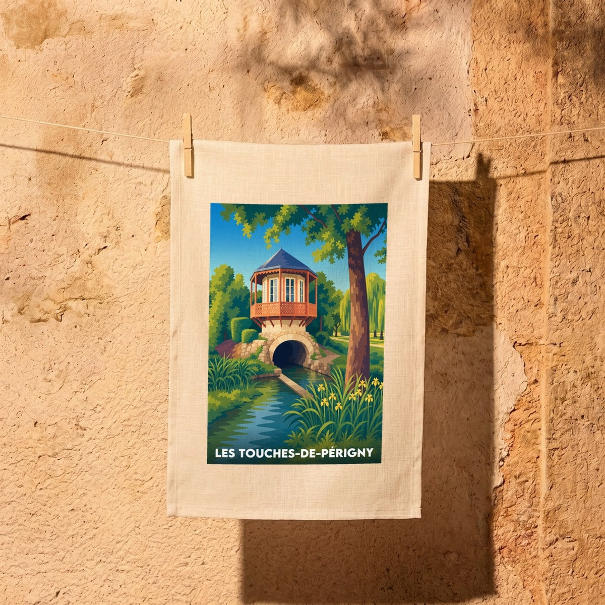 Torchon souvenir de Les Touches-de-Périgny avec une illustration stylisée d'un pavillon surplombant un cours d'eau.