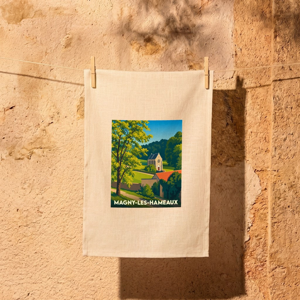 Torchon souvenir de la ville de Magny-les-Hameaux avec une illustration stylisée d'un paysage rural.