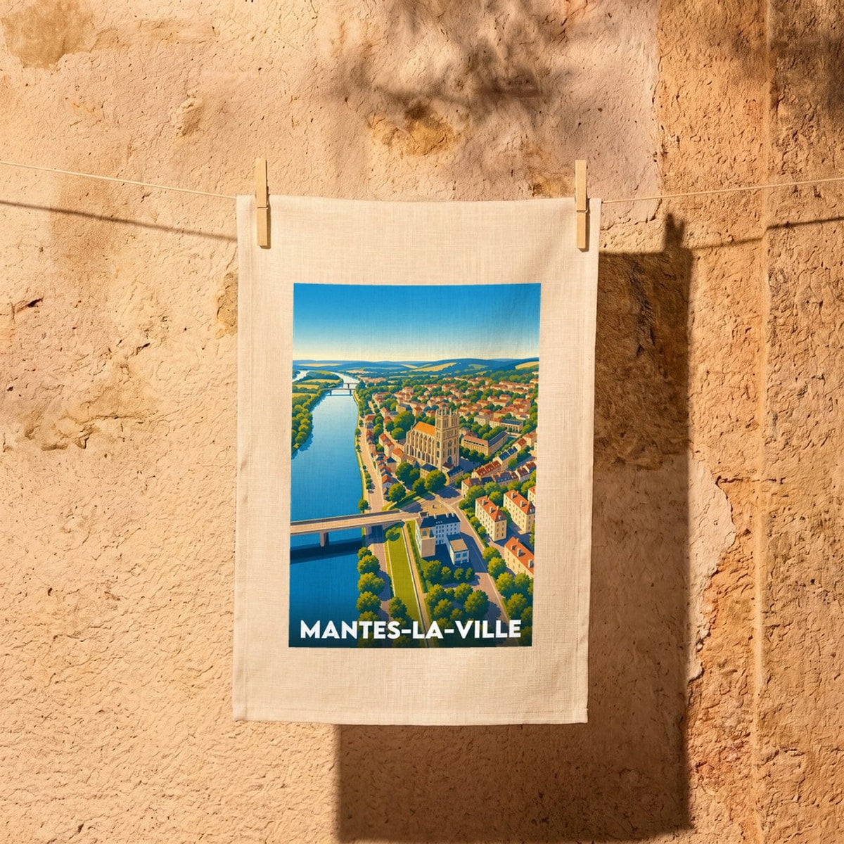 Torchon souvenir de la ville de Mantes-la-Ville avec une illustration panoramique stylisée.