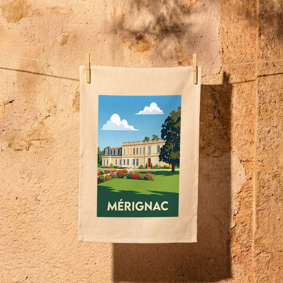 Torchon souvenir de la ville de Mérignac avec une illustration stylisée d'une demeure historique.