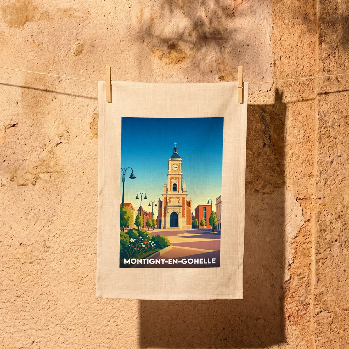Torchon souvenir de la ville de Montigny-en-Gohelle avec une illustration stylisée de son église et de sa place.