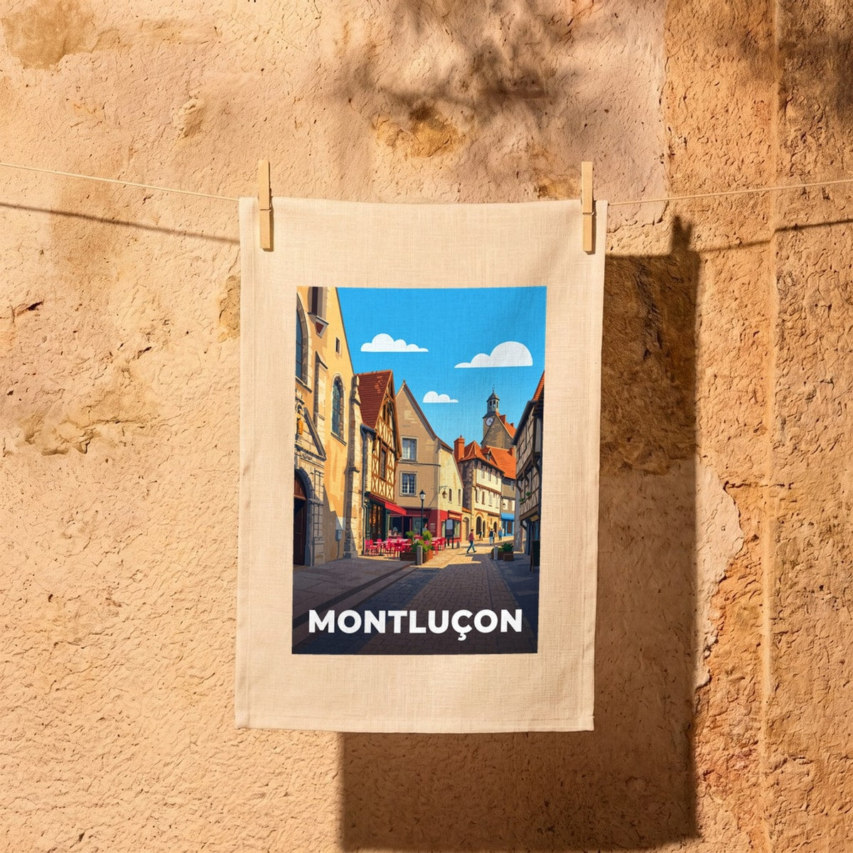 Torchon souvenir de la ville de Montluçon avec une illustration stylisée de ses rues.