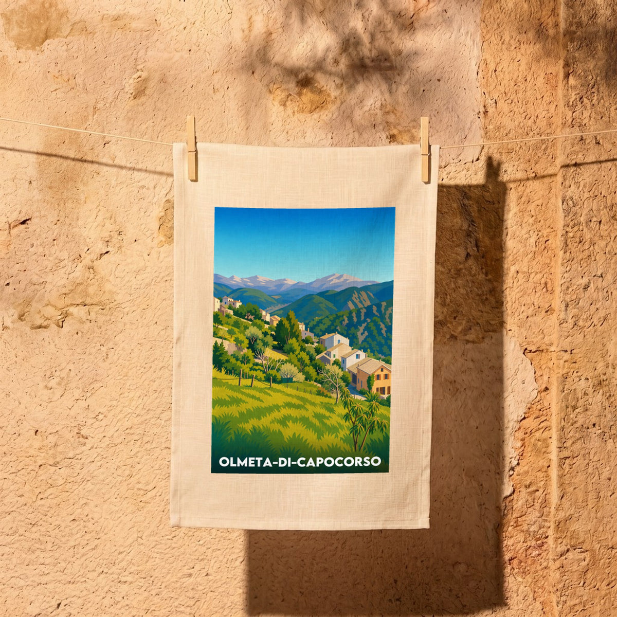 Torchon souvenir de la ville d'Olmeta-di-Capocorso avec une illustration stylisée de son paysage.