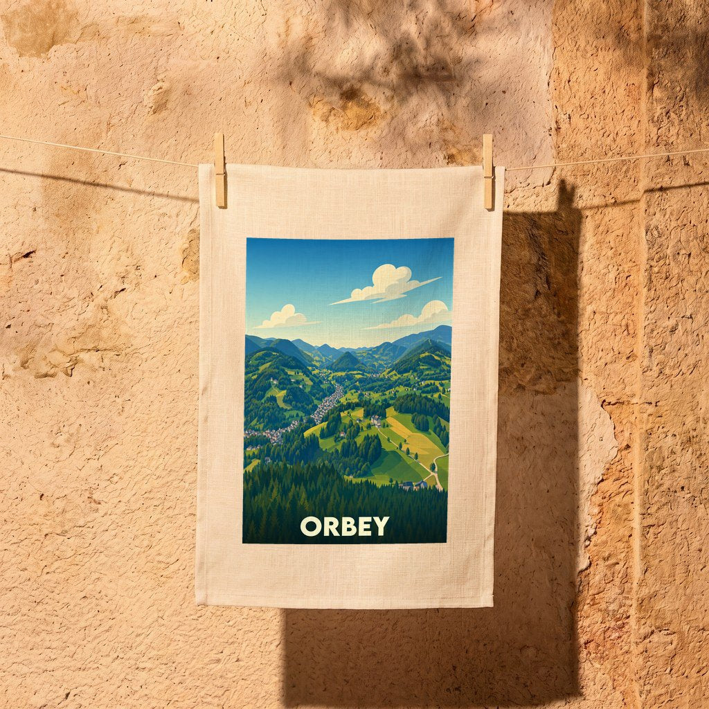 Torchon souvenir de la ville d'Orbey illustrant une vue panoramique stylisée de la vallée et de ses montagnes.