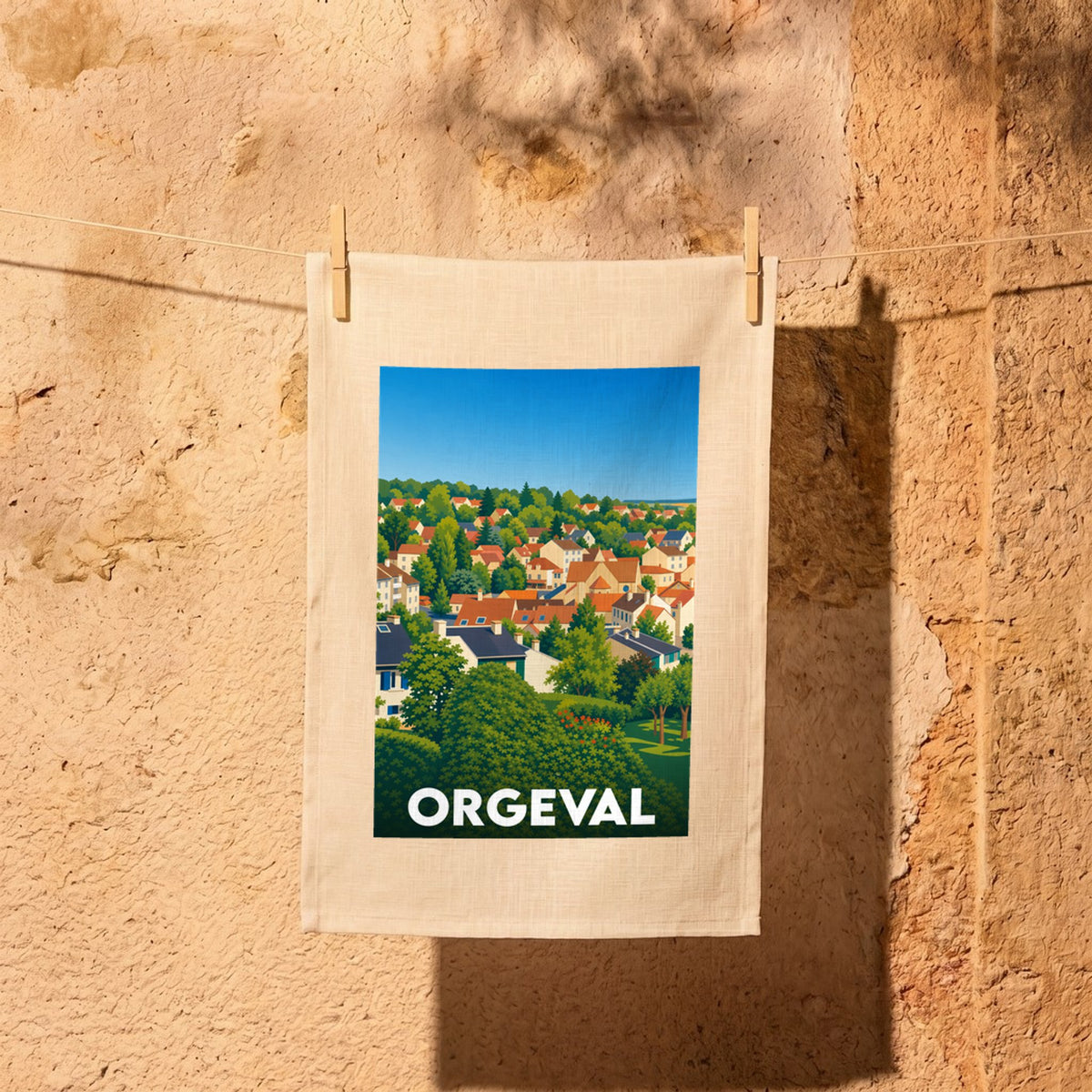 Torchon souvenir de la ville de Orgeval avec une illustration stylisée de ses toits et de sa végétation.