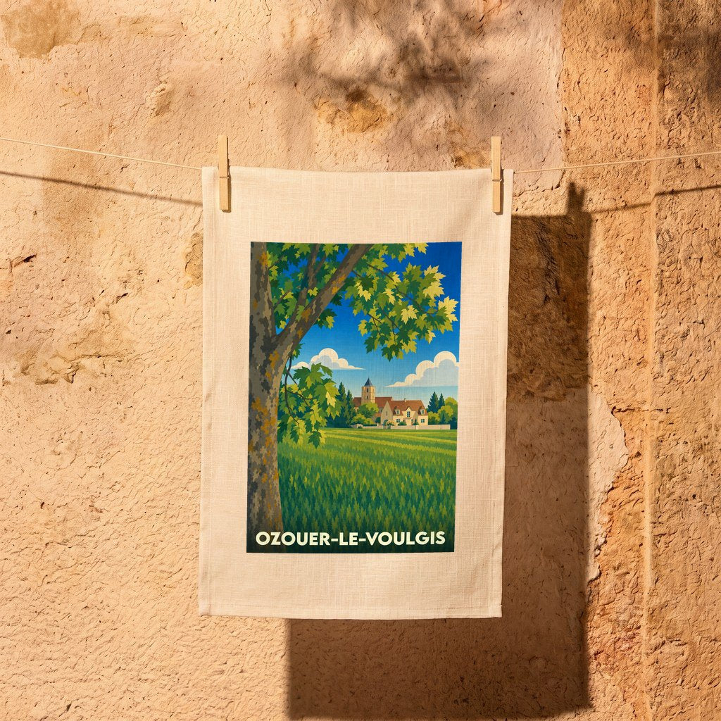 Torchon souvenir de la ville d'Ozouer-le-Voulgis avec une illustration champêtre stylisée.