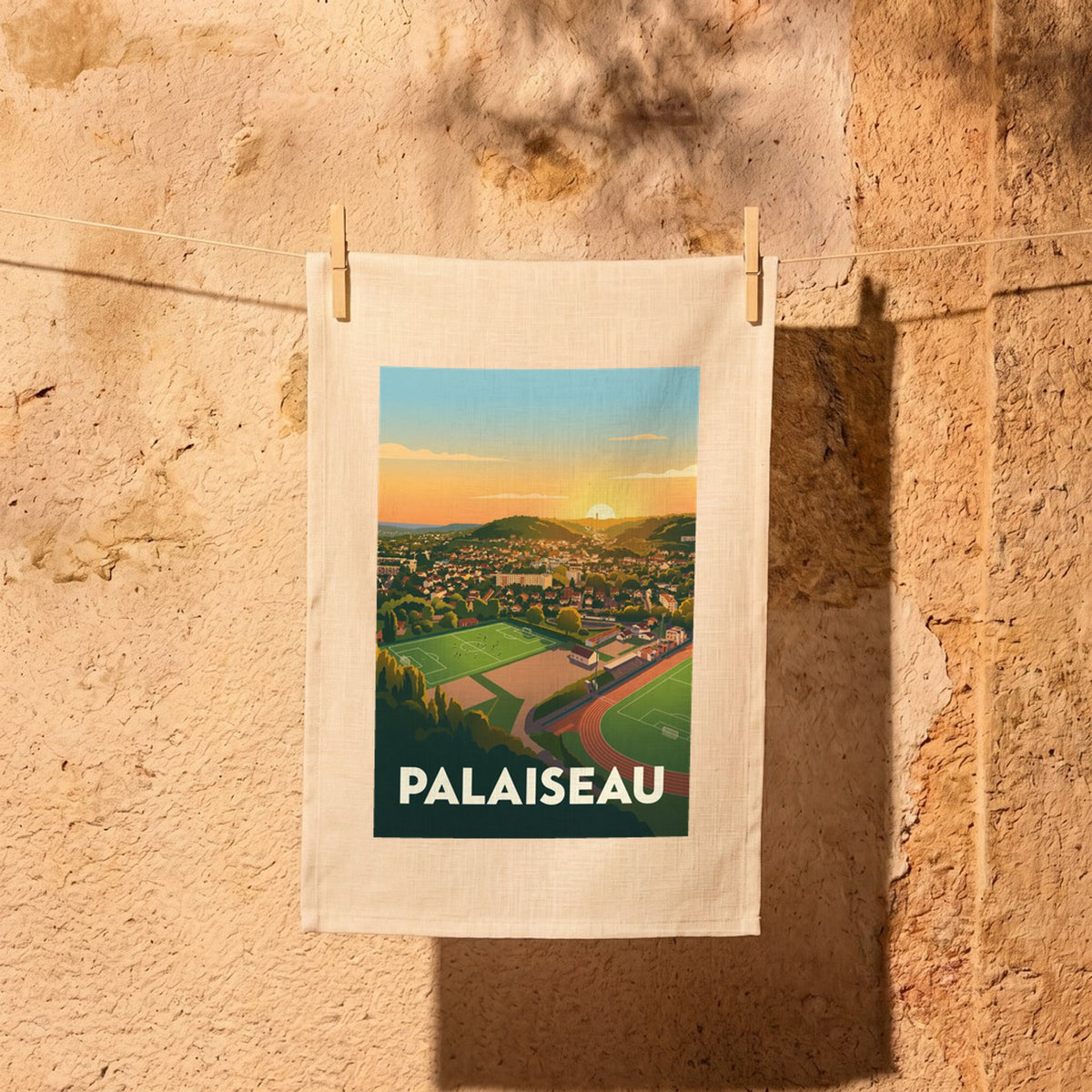 Torchon souvenir de la ville de Palaiseau avec une illustration stylisée et colorée de son paysage au coucher du soleil.