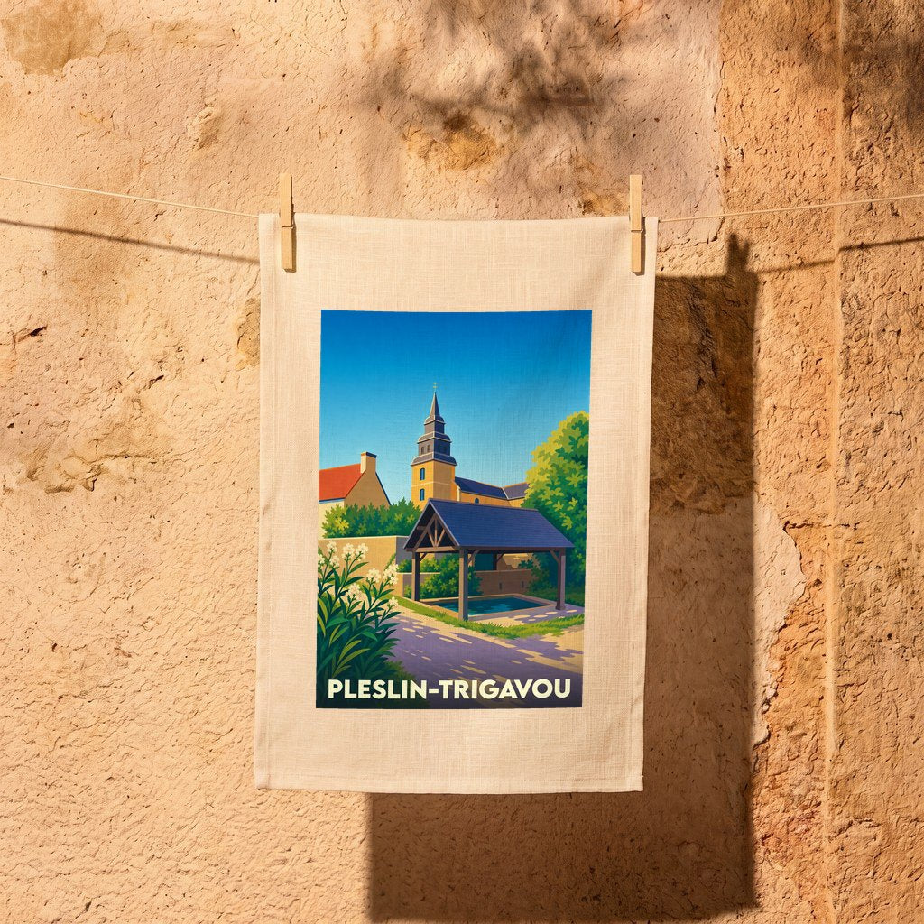 Torchon souvenir de la ville de Pleslin-Trigavou avec une illustration stylisée d'un lavoir et de l'église.