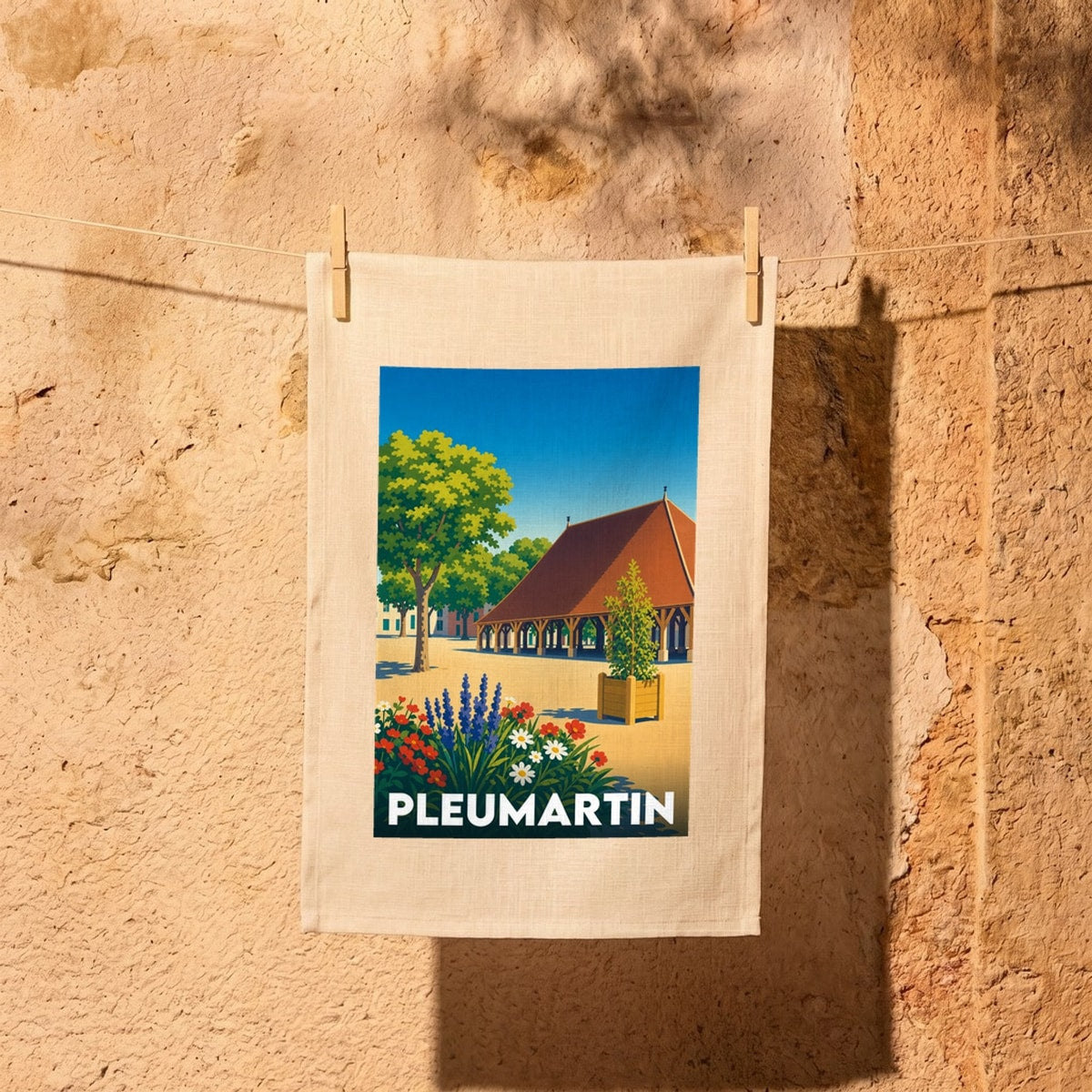 Torchon souvenir de la ville de Pleumartin avec une illustration stylisée.