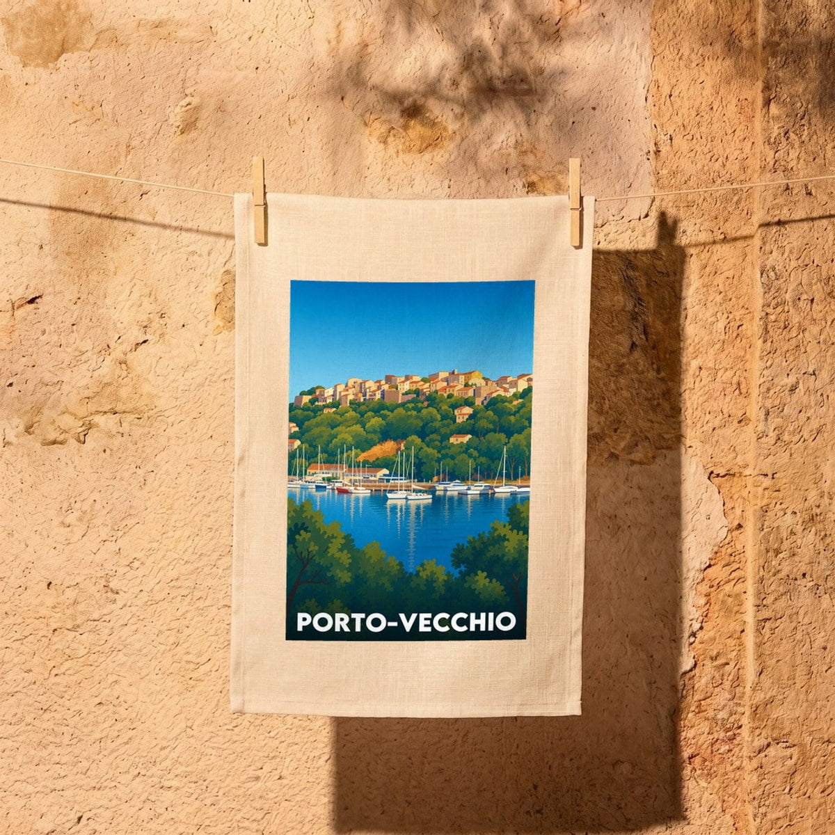Torchon souvenir de la ville de Porto-Vecchio avec une illustration stylisée de son port et de sa vieille ville.