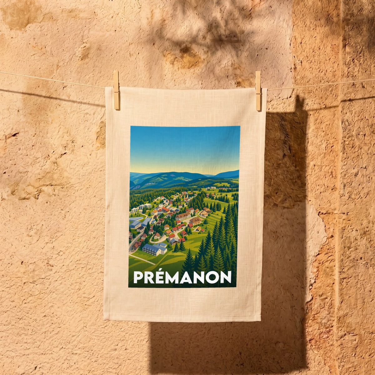 Torchon souvenir de la ville de Prémanon avec une illustration stylisée de son paysage de montagne.
