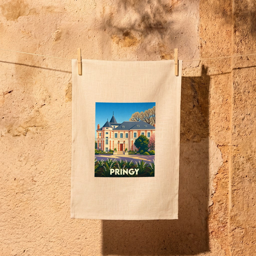 Torchon souvenir de la ville de Pringy avec une illustration stylisée d'un manoir et d'un parterre de fleurs.