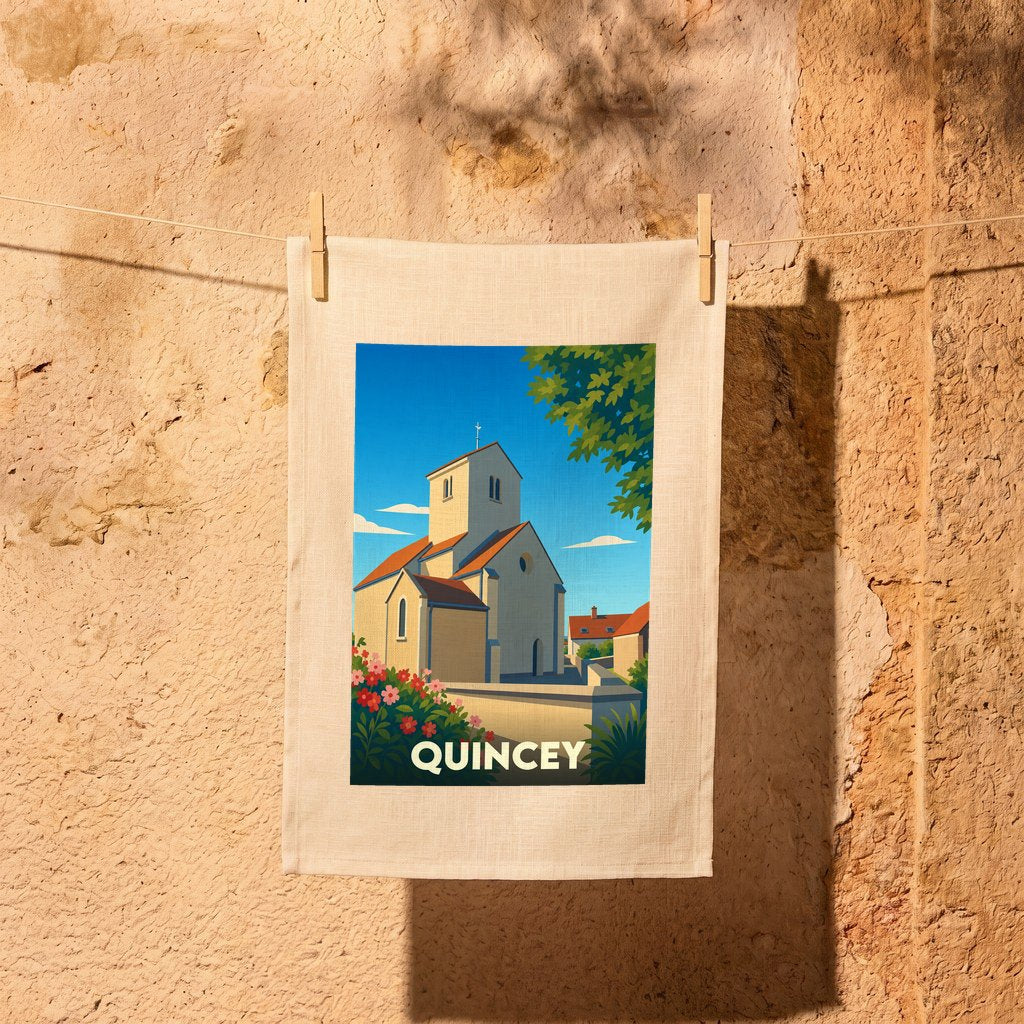 Torchon souvenir de la ville de Quincey avec une illustration stylisée de son église sous un ciel bleu.