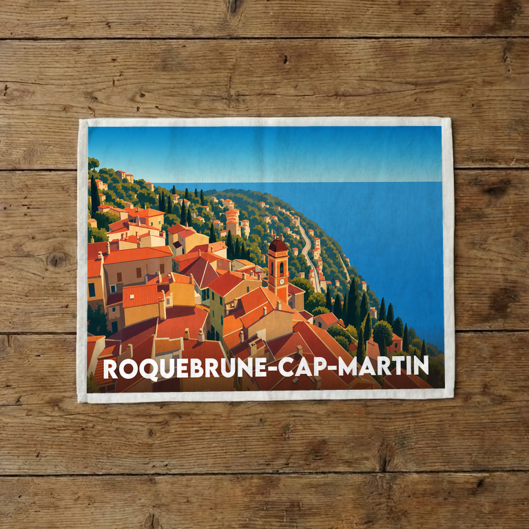 Torchon souvenir de la ville de Roquebrune-Cap-Martin orné d'une illustration stylisée du village perché en bord de mer.