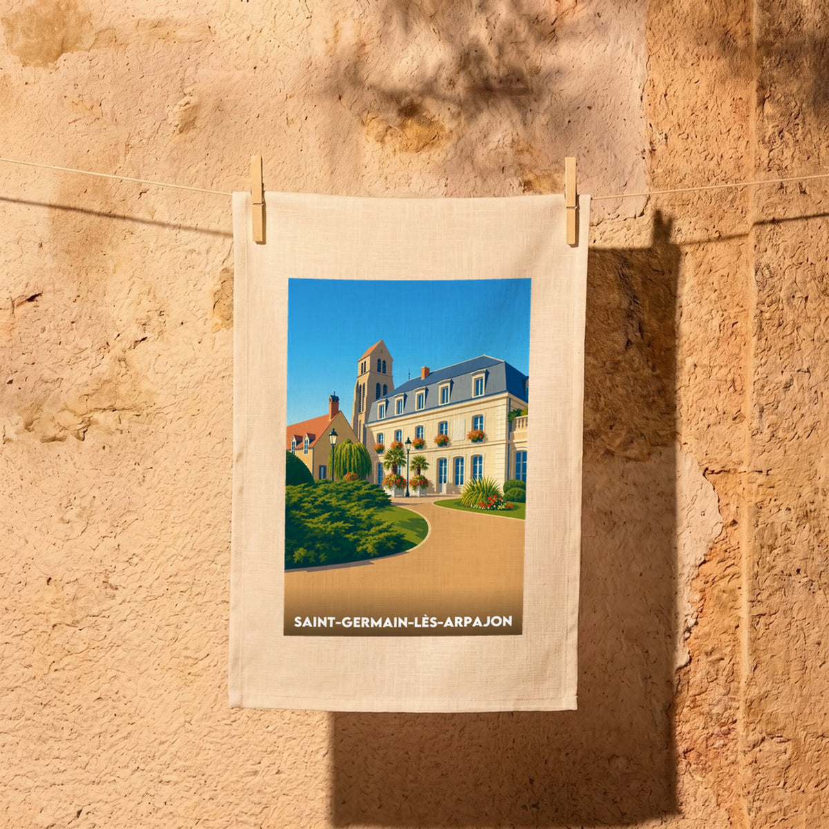 Torchon souvenir de la ville de Saint-Germain-lès-Arpajon illustré d'un paysage urbain stylisé.
