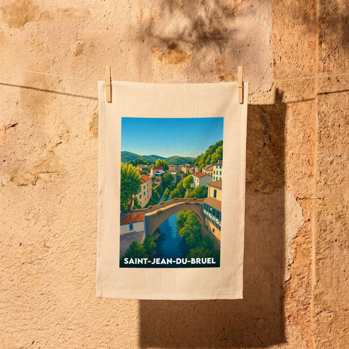 Torchon souvenir de la ville de Saint-Jean-du-Bruel avec une illustration stylisée.