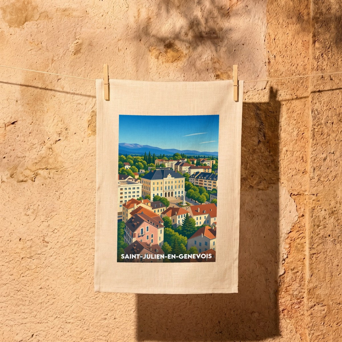 Torchon souvenir de la ville de Saint-Julien-en-Genevois avec une illustration stylisée de son paysage urbain.