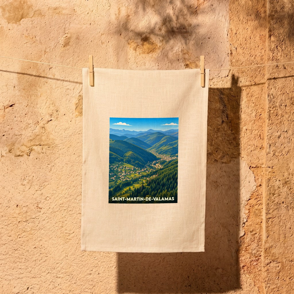 Torchon souvenir de la ville de Saint-Martin-de-Valamas avec une illustration stylisée d'un paysage montagneux.
