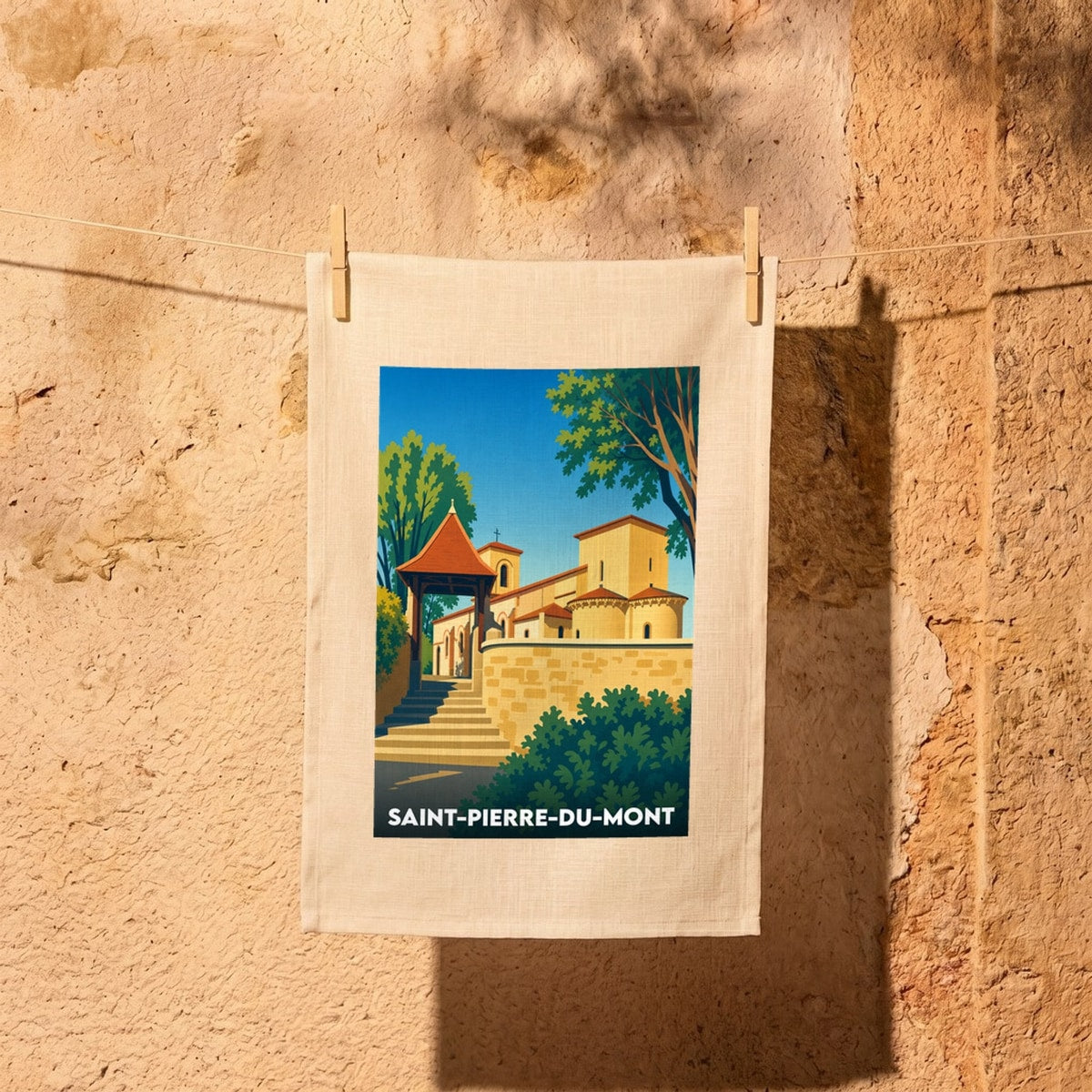 Torchon souvenir de la ville de Saint-Pierre-du-Mont avec une illustration stylisée de son église.