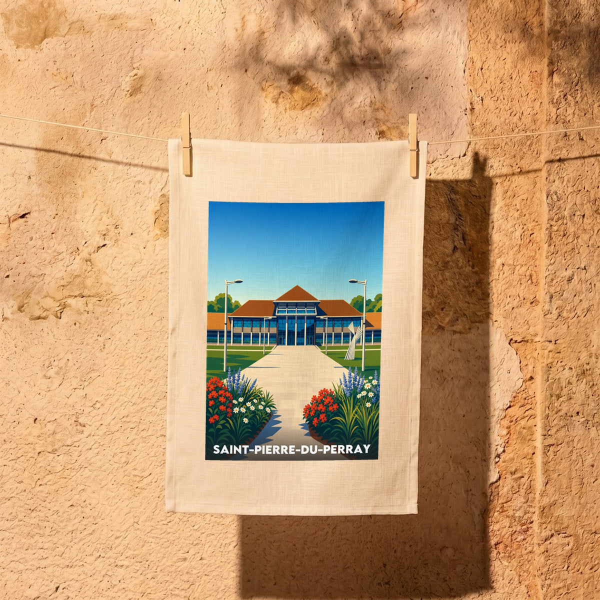 Torchon souvenir de la ville de Saint-Pierre-du-Perray avec une illustration stylisée d'un bâtiment et de jardins.