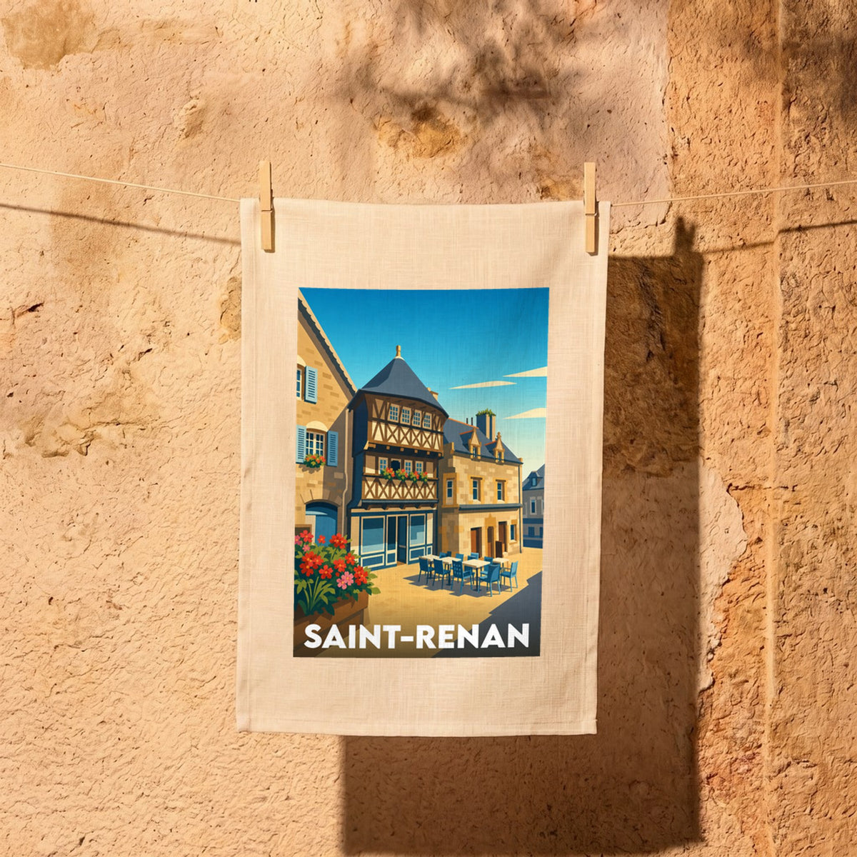 Torchon souvenir de la ville de Saint-Renan avec une illustration stylisée de ses maisons à pans de bois.