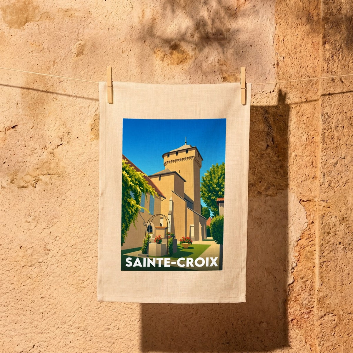 Torchon souvenir de la ville de Sainte-Croix avec une illustration stylisée de son église.