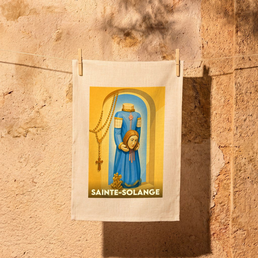 Torchon souvenir de la ville de Sainte-Solange avec une illustration stylisée d'une sainte céphalophore.