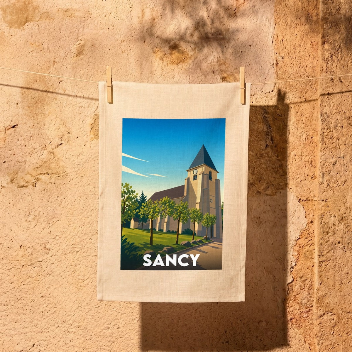 Torchon souvenir de la ville de Sancy avec une illustration stylisée de son église.