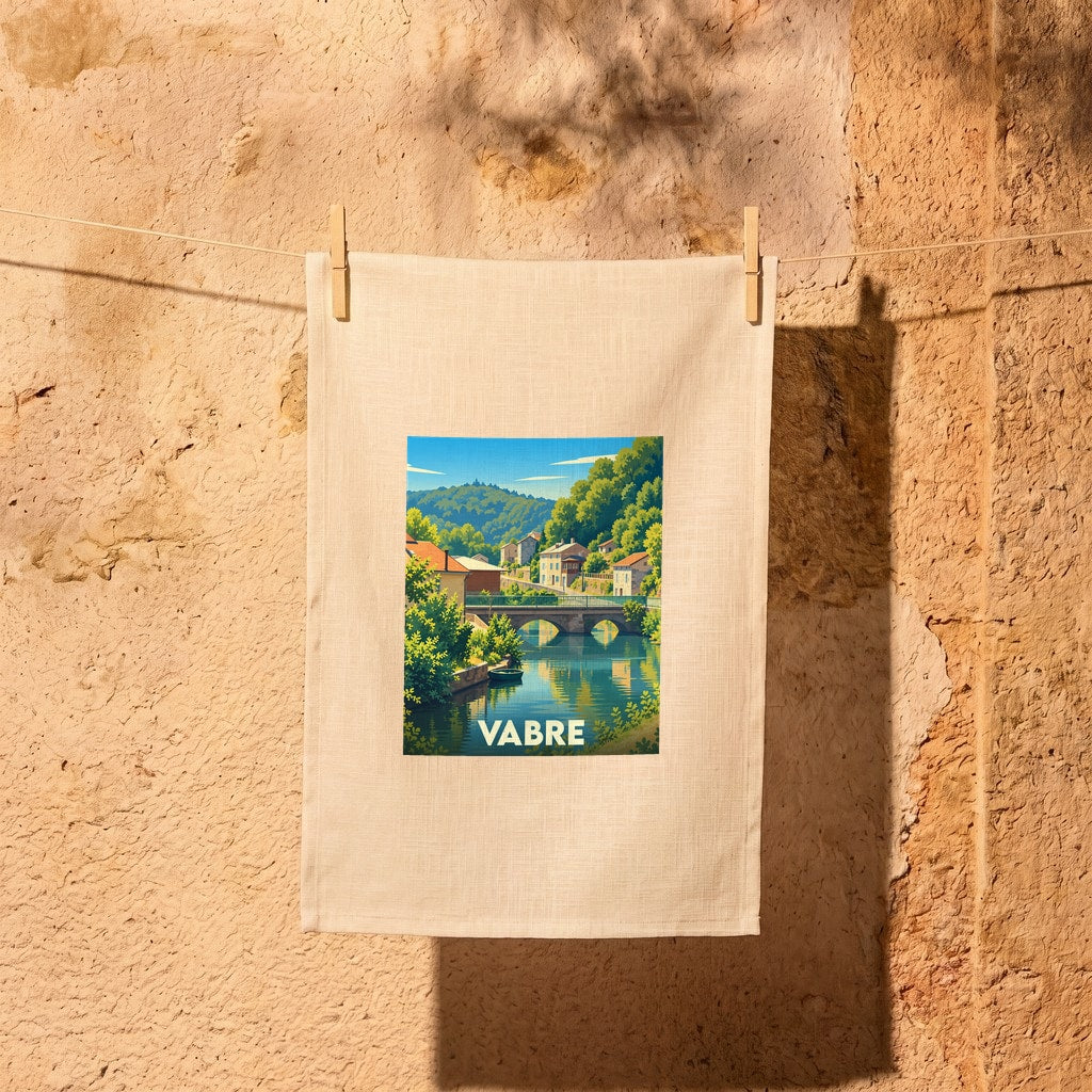 Torchon souvenir de la ville de Vabre avec une illustration stylisée d'un pont enjambant une rivière.