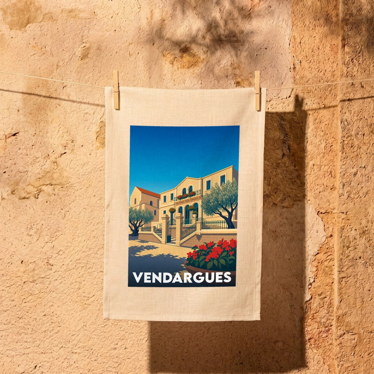 Torchon souvenir de la ville de Vendargues orné d'une illustration stylisée de son architecture locale.
