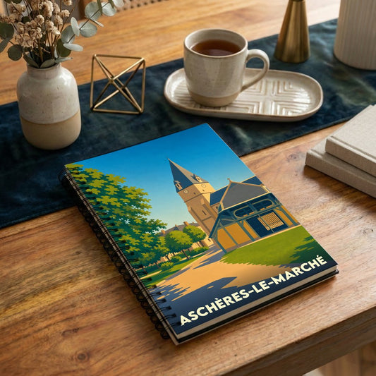 Carnet souvenir de la ville d'Aschères-le-Marché avec une illustration stylisée de son église et de ses halles.