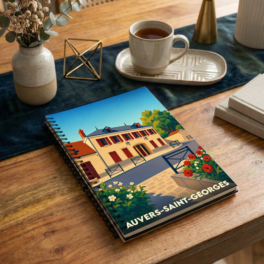 Carnet à spirales souvenir de la ville d'Auvers-Saint-Georges avec une illustration stylisée.
