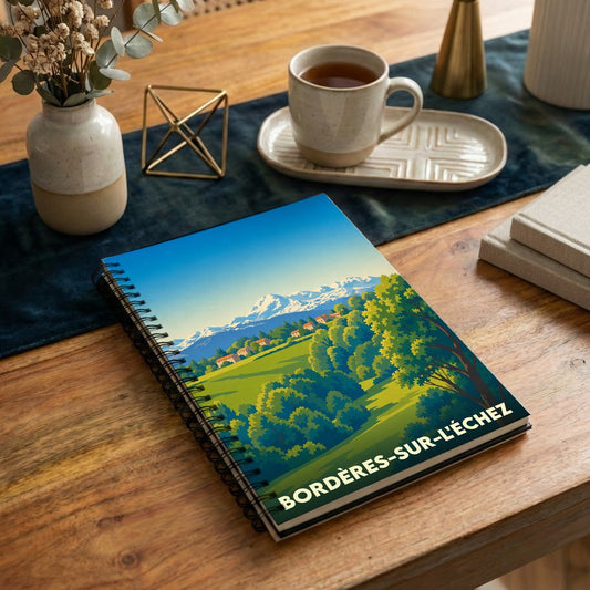 Carnet à spirales souvenir de la ville de Bordères-sur-l'Échez avec une illustration de paysage de montagne stylisée.