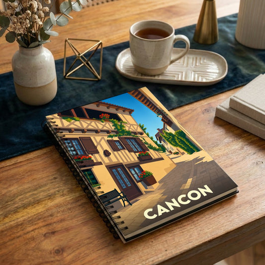 Carnet souvenir de la ville de Cancon avec une illustration stylisée d'une rue pittoresque.