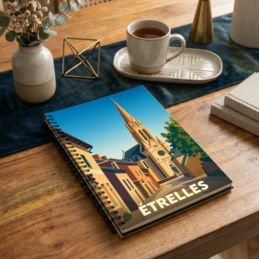 Carnet souvenir de la ville d'Étrelles avec une illustration stylisée de son église et de ses rues.