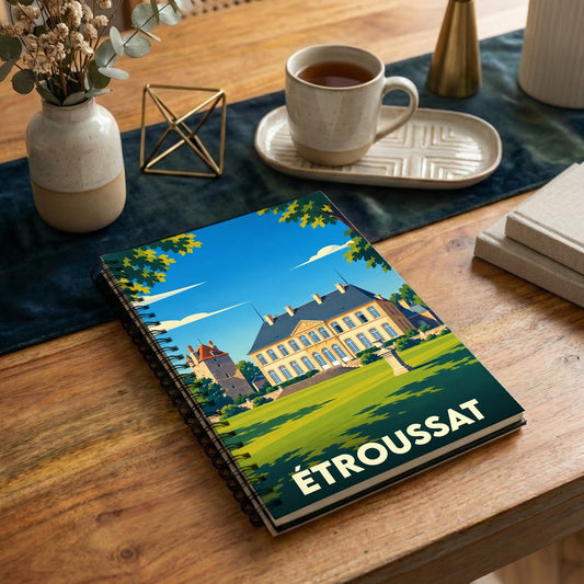 Carnet à spirales souvenir de la ville de Étroussat avec une illustration stylisée de son château.