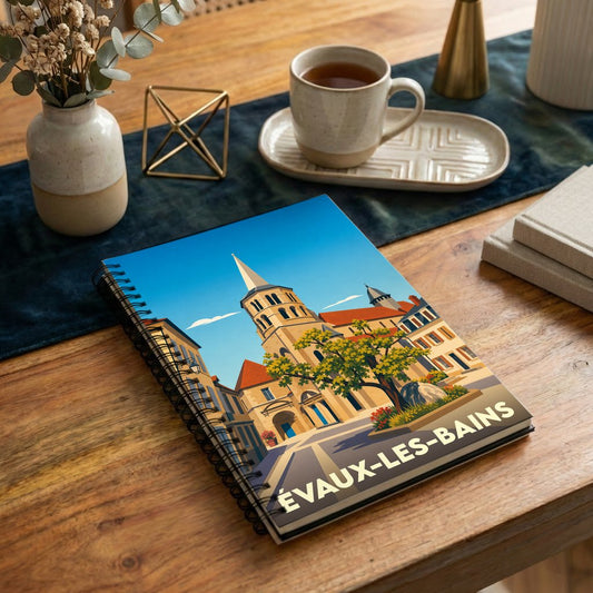 Carnet souvenir de la ville d'Évaux-les-Bains avec une illustration stylisée de son église et de sa place fleurie.