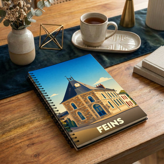 Carnet à spirales souvenir de la ville de Feins avec une illustration stylisée de sa mairie.