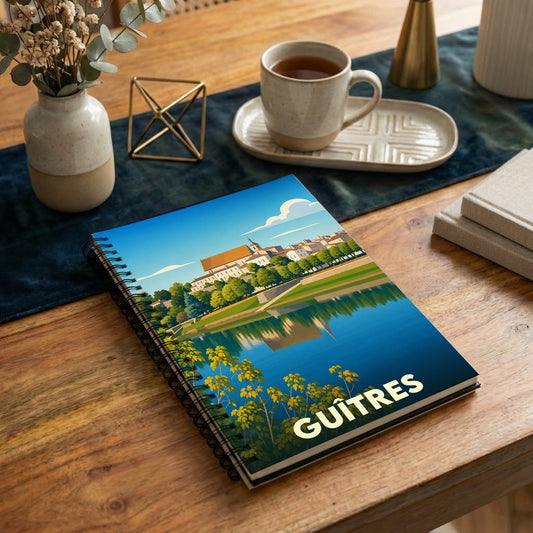 Carnet souvenir de la ville de Guîtres illustré par une vue stylisée de son église se reflétant dans l'eau.