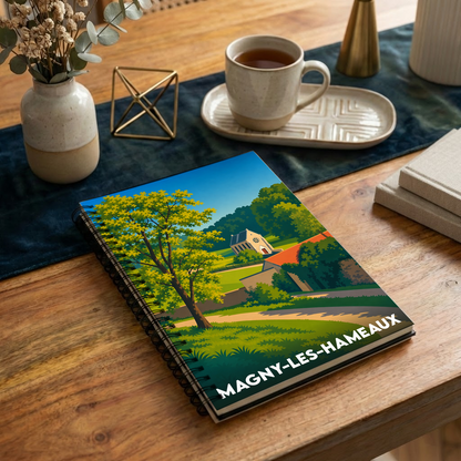 Carnet à spirales souvenir de la ville de Magny-les-Hameaux avec une illustration de paysage stylisée.