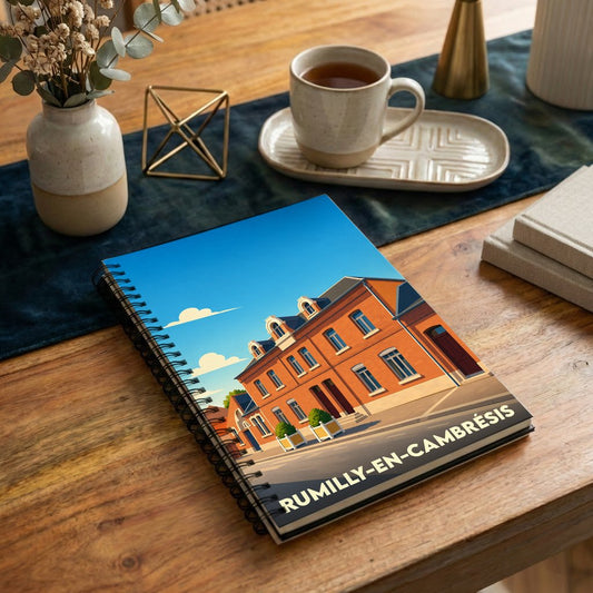Carnet à spirales souvenir de la ville de Rumilly-en-Cambrésis avec une illustration stylisée d'un bâtiment en briques.