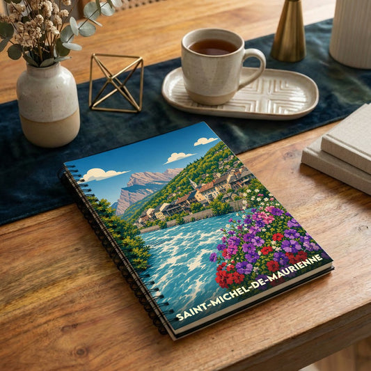 Carnet à spirales souvenir de la ville de Saint-Michel-de-Maurienne avec une illustration paysagère stylisée.