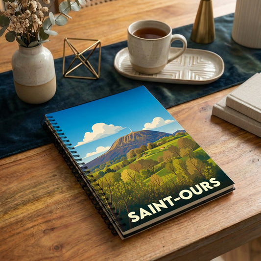 Carnet à spirales souvenir de la ville de Saint-Ours avec une illustration stylisée d'un paysage de montagne.