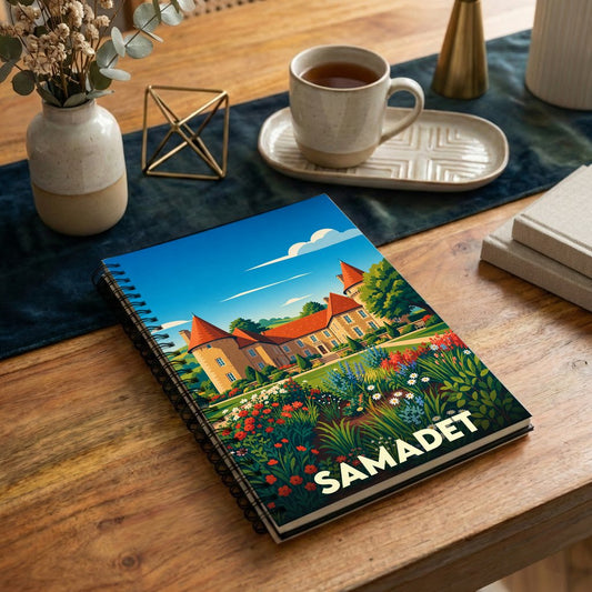 Carnet à spirales souvenir de la ville de Samadet avec une illustration stylisée de château et de jardins fleuris.
