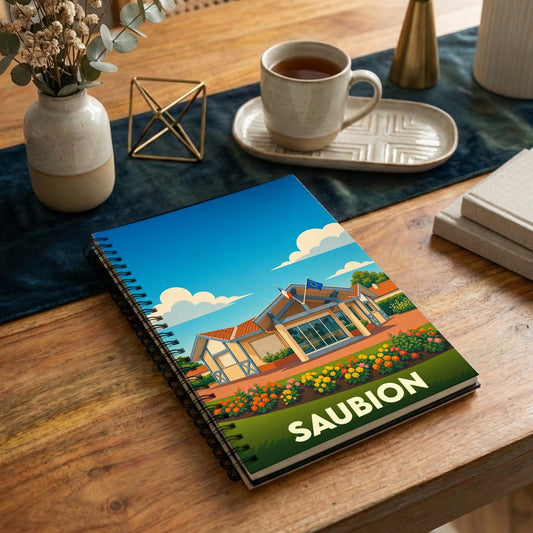 Carnet à spirales souvenir de la ville de Saubion avec une illustration stylisée et colorée.